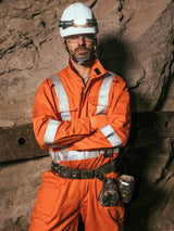 Worker wearing orange Style 408 hi-vis FR coveralls